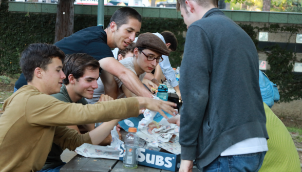 Students reach in to grab another succulent Jersey Mike's sub from the box