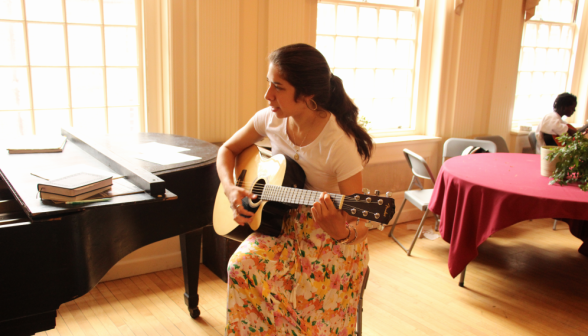 A prefect plays guitar