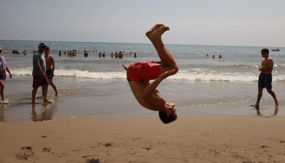 A student upside-down, midway through a 360 backflip