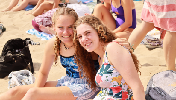 Two on the beach smile for the camera