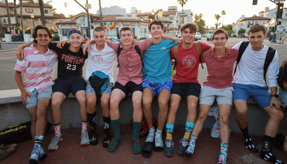 Several pose together on a bench