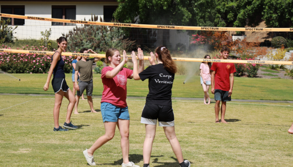 Students high-five at volleyball