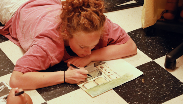 A student draws a picture of the gym