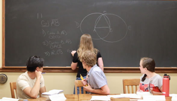 A student does a prop at the board