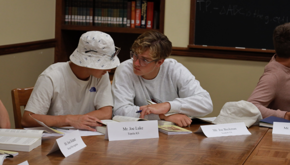 Two study together at the table