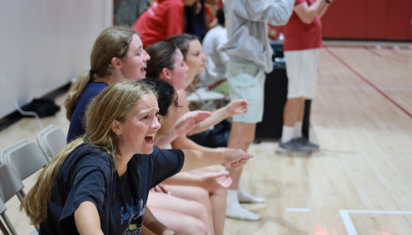 Spectators cheer from the sidelines