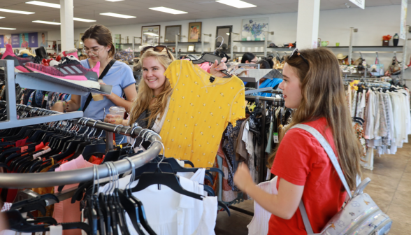 Several peruse the clothing aisles