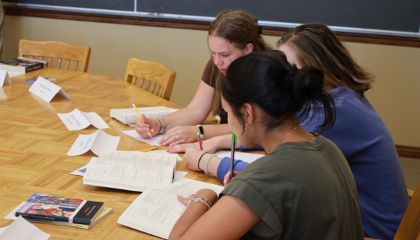 Three study at the table