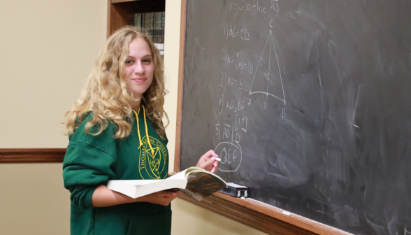 A student practices at the board