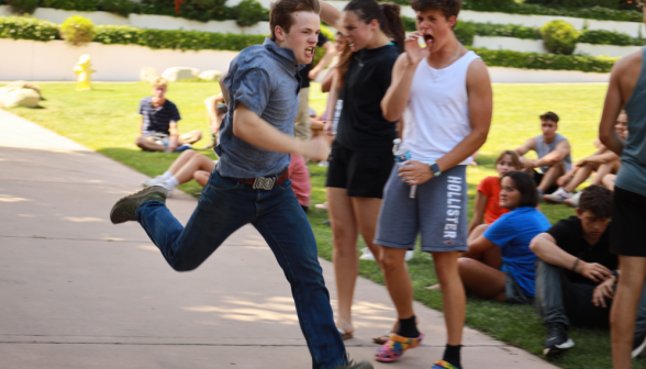 A student runs past the finish line