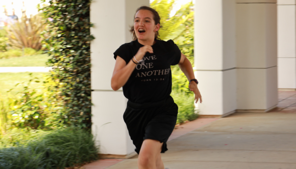A student runs down the arcade