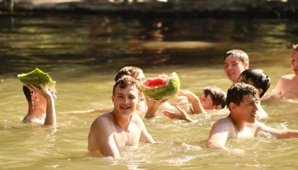 Students hold up melon fragments