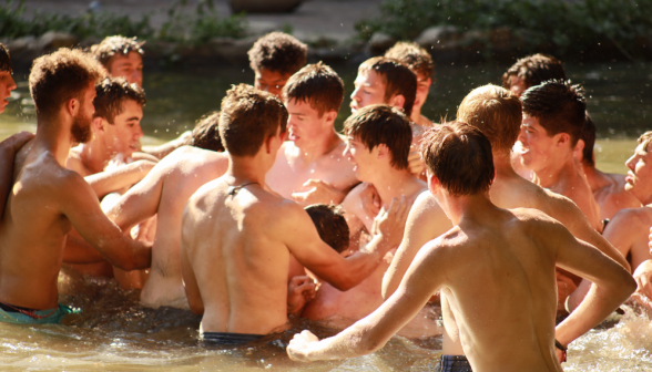 Several wrestle in the middle of the pond