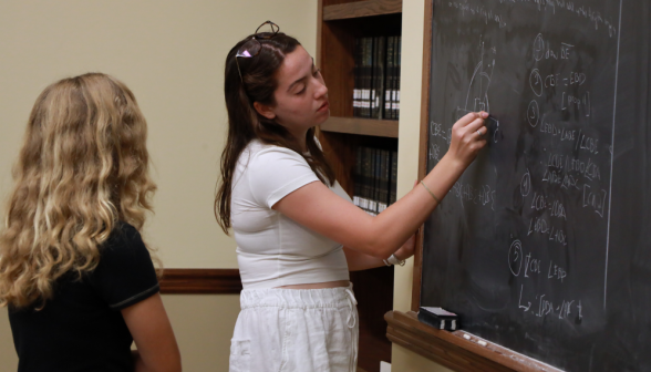 A student does a prop at the board