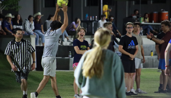 A student holds the ball over his head