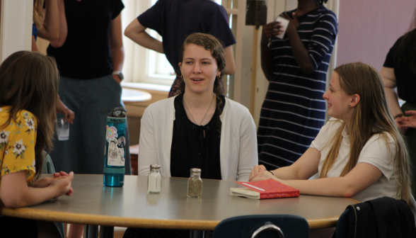 Students chat at one of the lunch tables