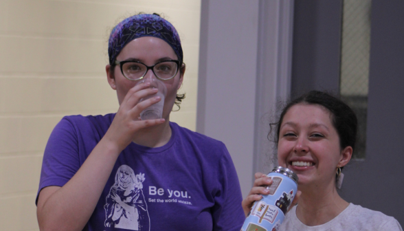 Two drink water and smile for the camera