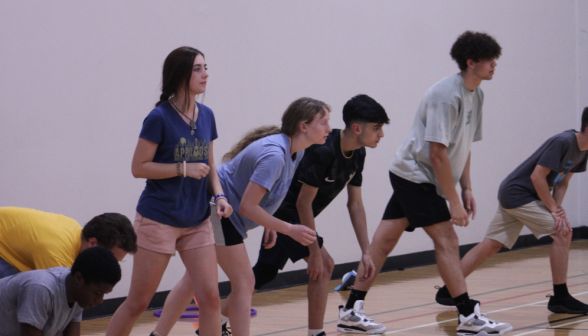 Students line up against the wall to dash