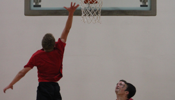 A prefect makes a shot on the basket