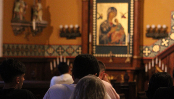 Students pray before the icon of Our Mother of Perpetual Help