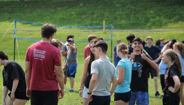 Amid a cluster of students, one gives the camera a double thumbs-up