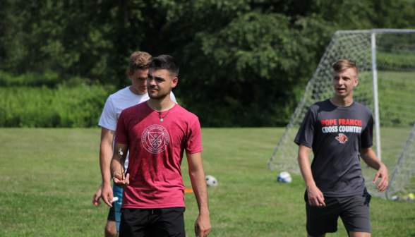 Three look on from next to the soccer net