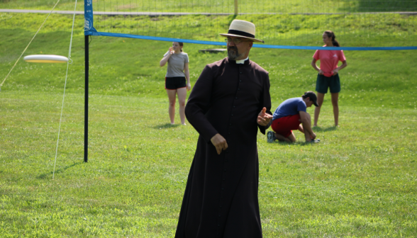 Fr. Viego walks on the athletic field