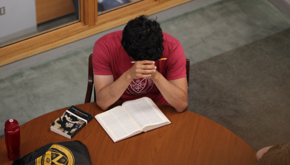 A student studies at a table
