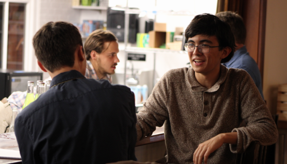 Students chat at the coffee shop counter