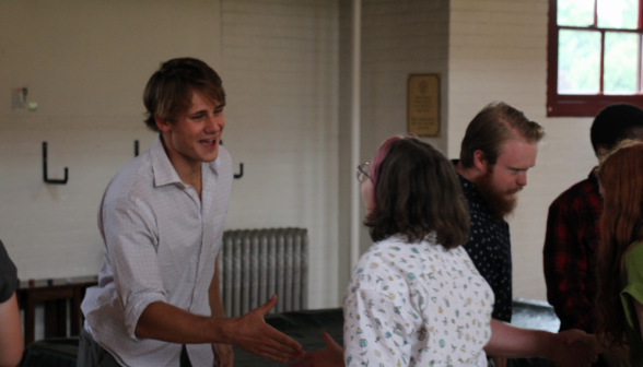 Students shake hands with their partners