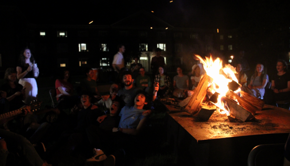 Students sing around the bonfire