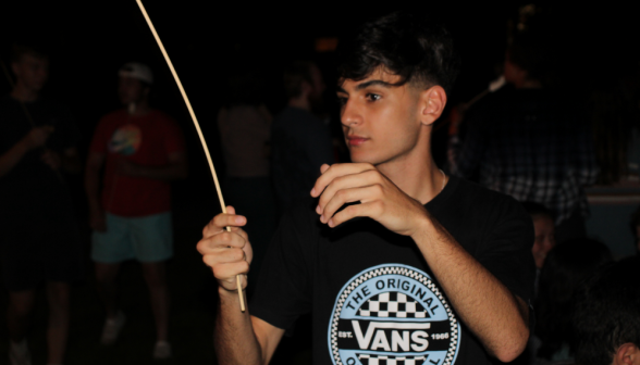 A student prepares to roast a marshmallow