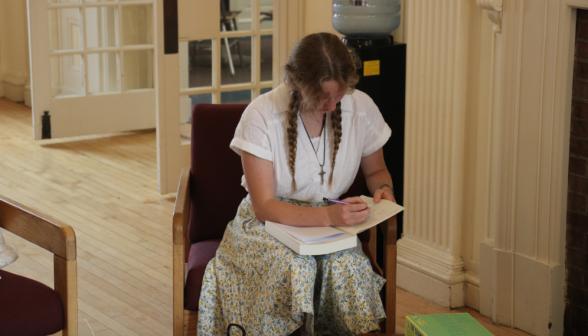 A student studies props in the Commons