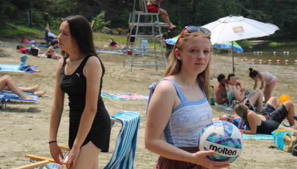 A student holds a volleyball