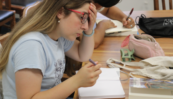 A student practices in a notebook