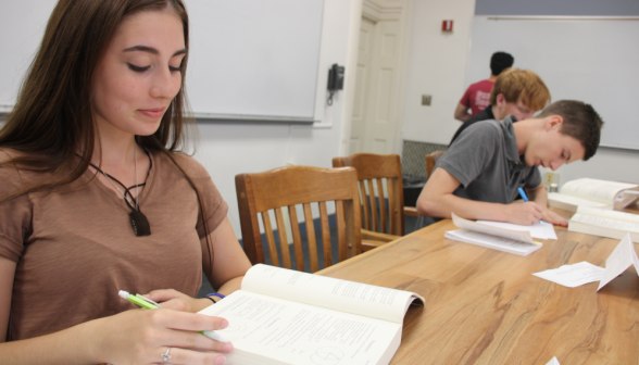 A student reviews Prop 1 at the table