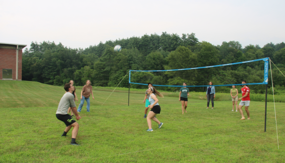 A student about to hit the downcoming volleyball