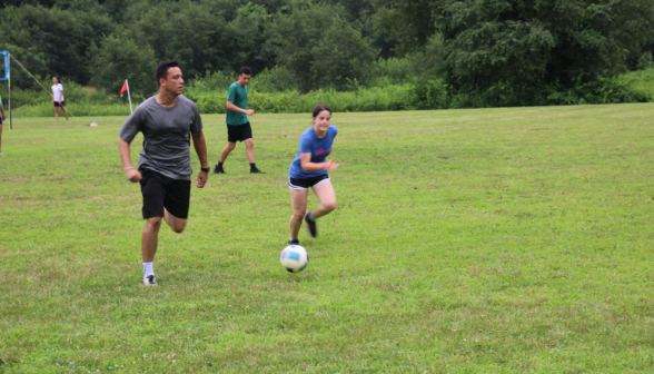 A student races down the field with the ball