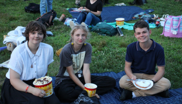 Three pose with popcorn and fried dough