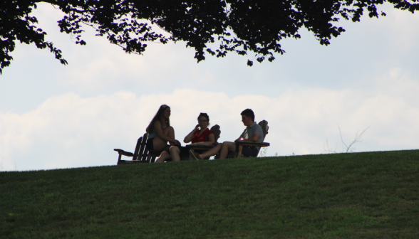 Three silhouetted in Adirondack chairs