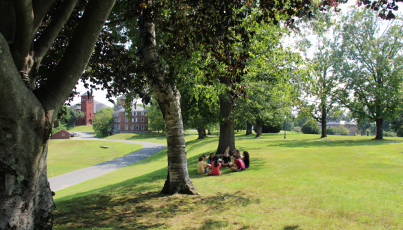 Long shot of eight chatting seated in a circle