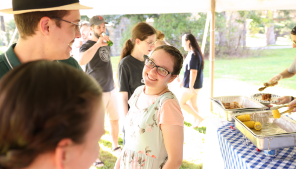 A young woman smiling at a young man.