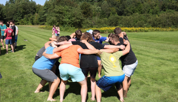 A group of young men in a huddle.