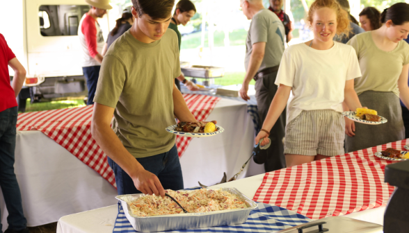 A young man serves himself food.