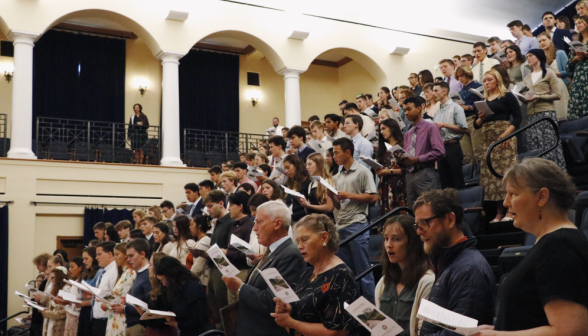 Students stand and sing