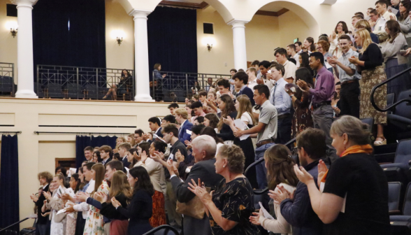 The students stand and applaud