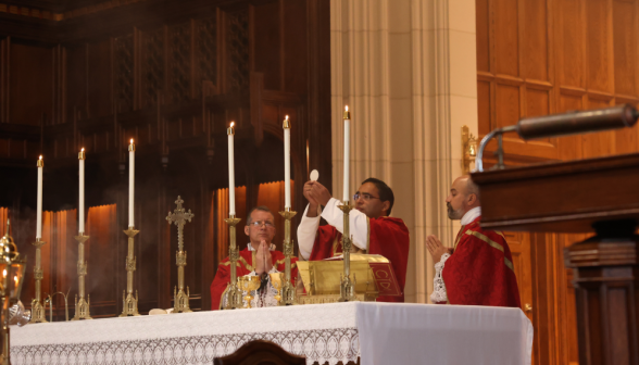 Fr. Miguel offers the Body