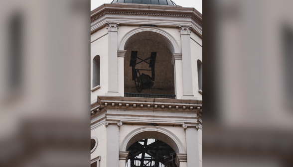 The chapel bell hangs precariously