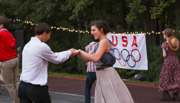 Dancing in front of the olympics sign