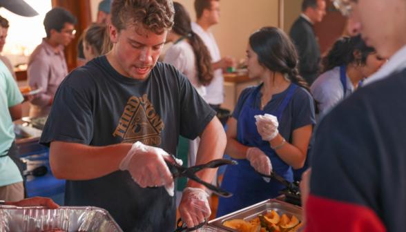 Sophomore Jack M. serves dinner